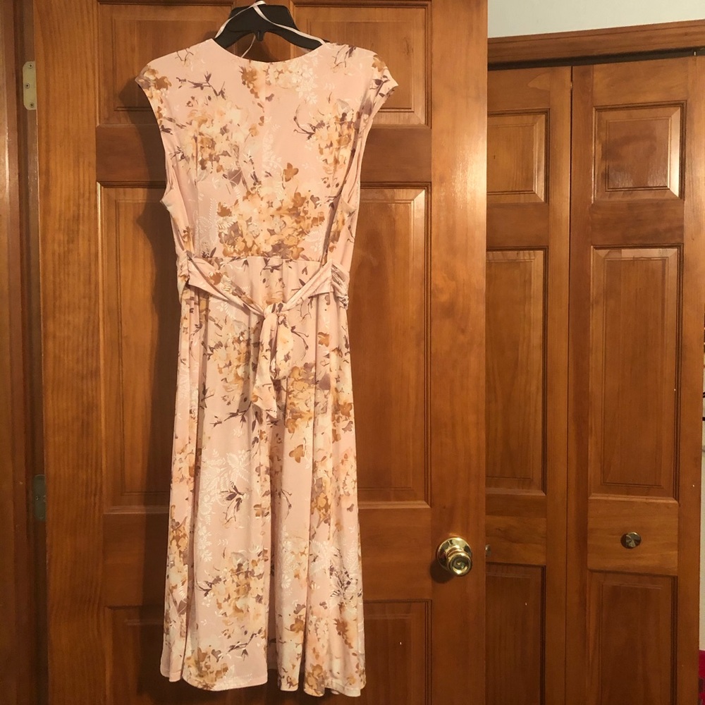 Pink knee length dress.